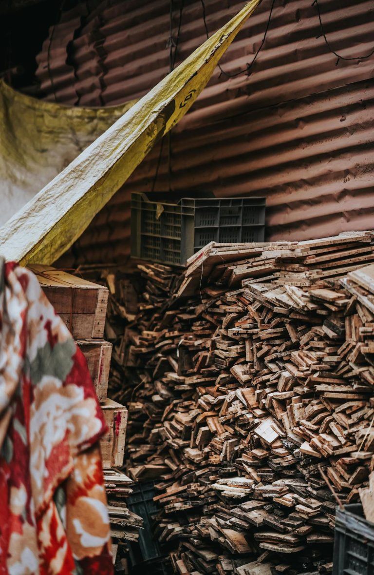 A rustic scene with a pile of chopped wood in an outdoor Indian market, Nagpur, India.